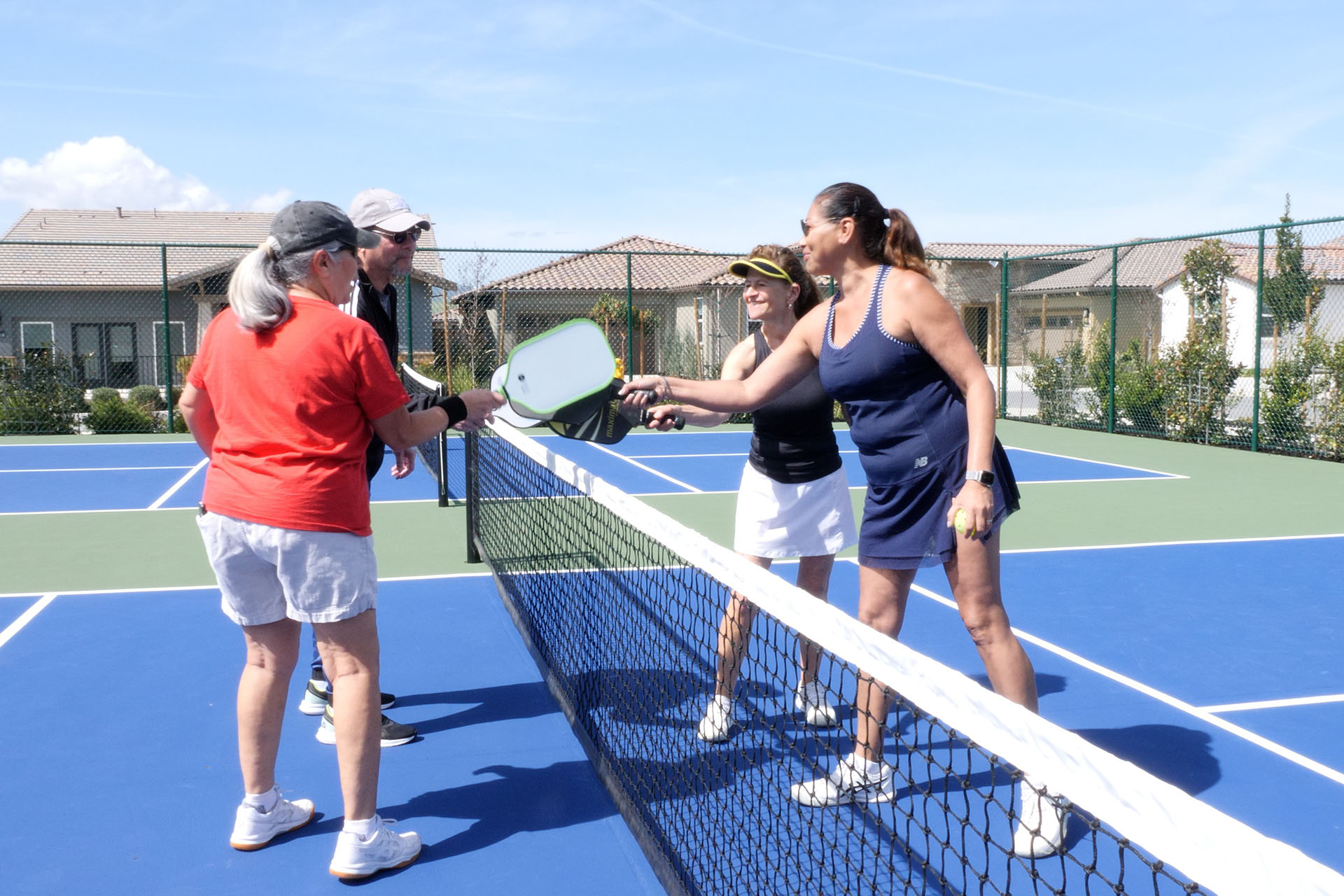 55+ community residents playing pickleball